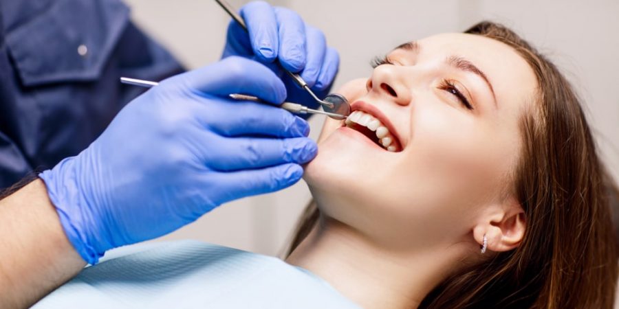 woman having a dental cleaning as preventive dentistry