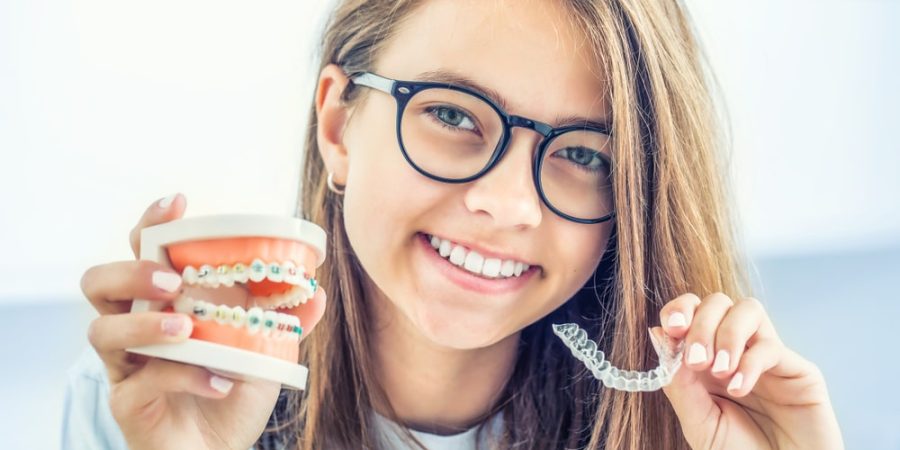 shutterstock_1515575504-min child with braces and invisalign | orthodontics